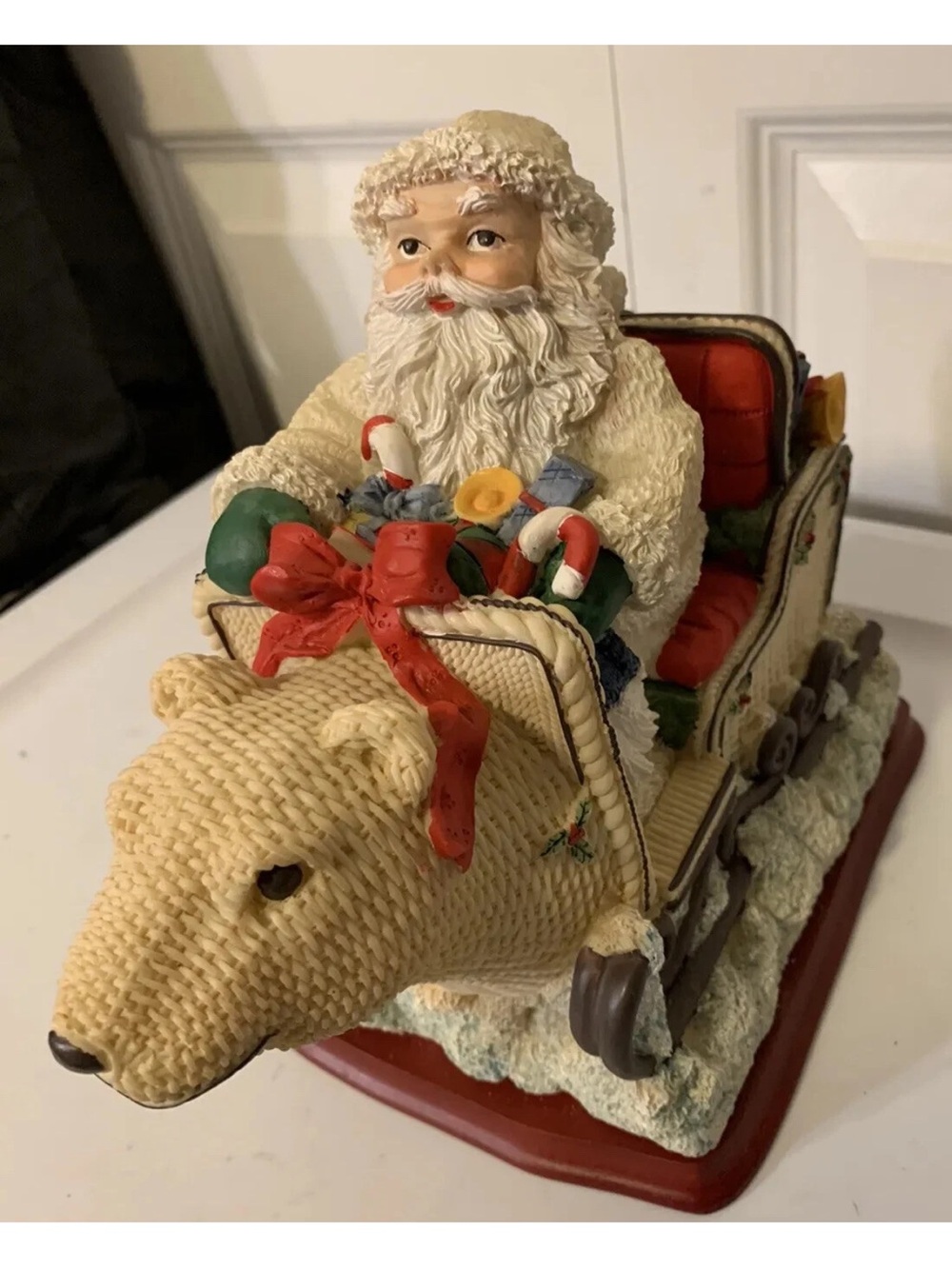 Festive Santa on Cream Polar Bear Sleigh Figurine with Red Accents